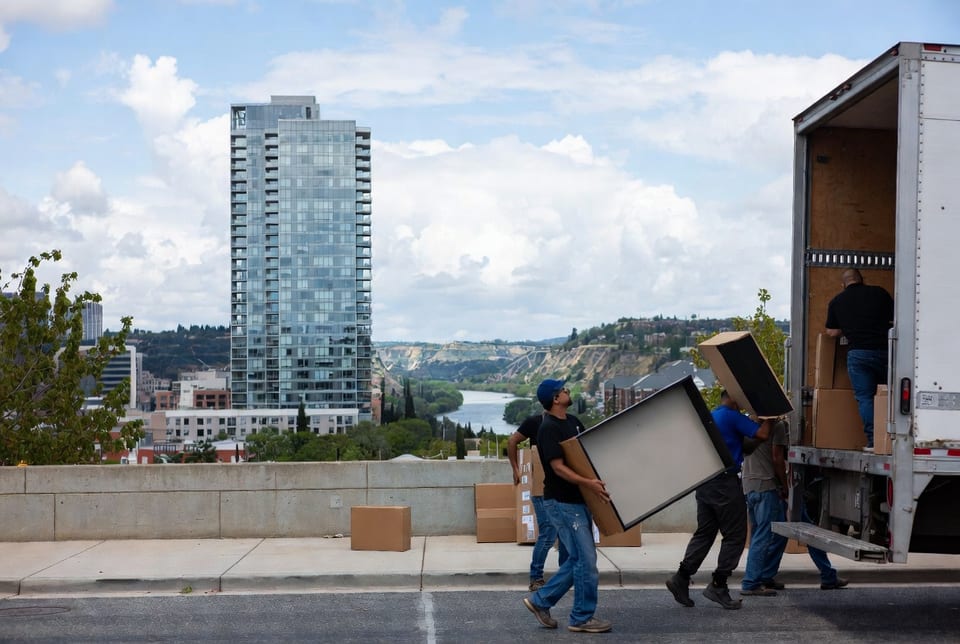 Moving truck parked on Jasper Avenue during a sunny winter afternoon in Edmonton