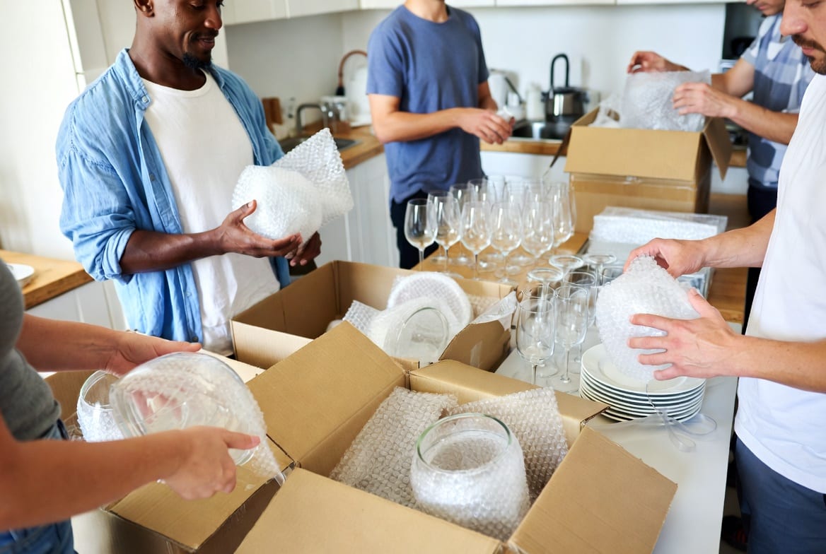 Packing specialists preparing fragile belongings for cross-country transport